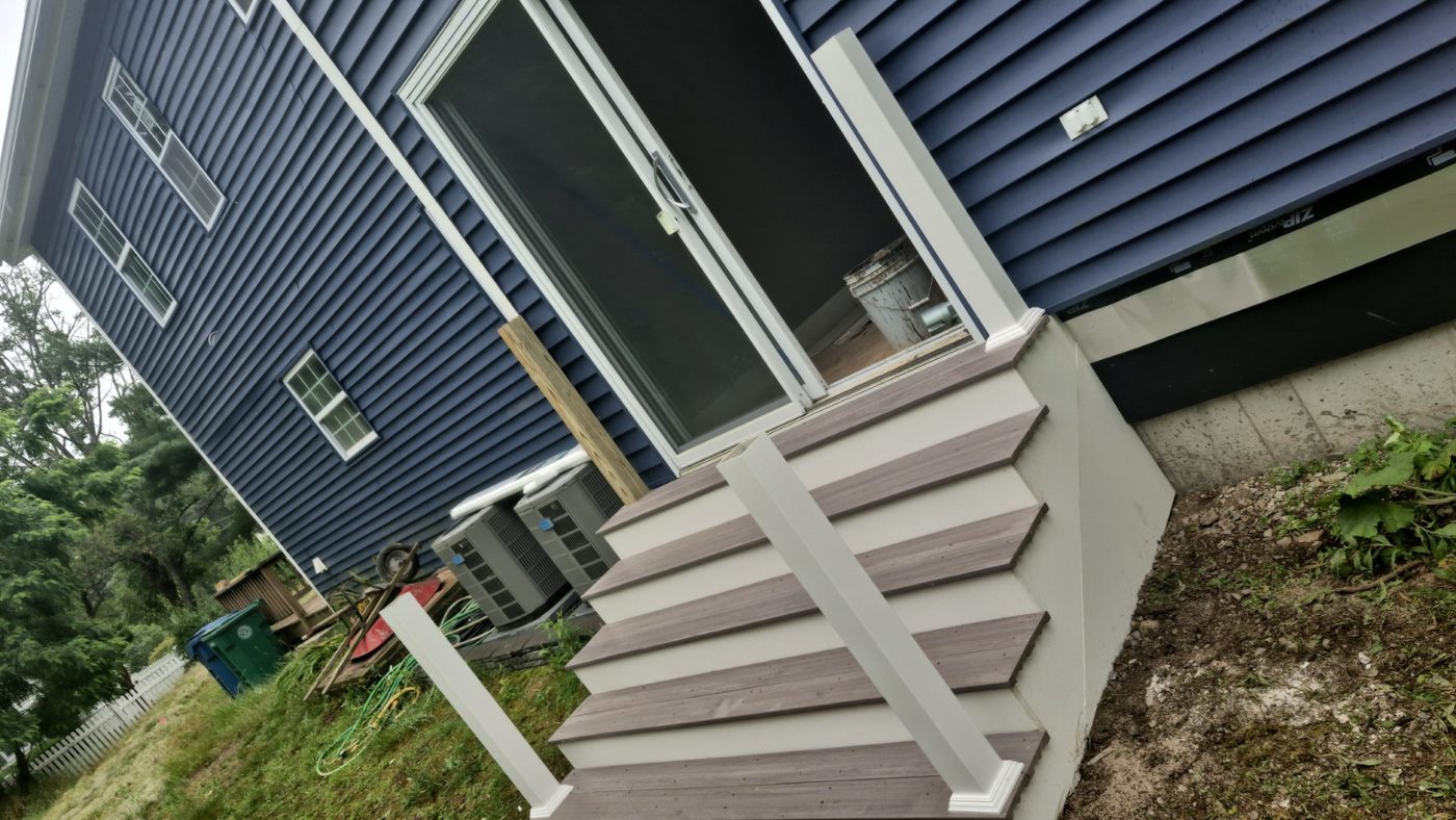 Finished porch stairs on a blue house